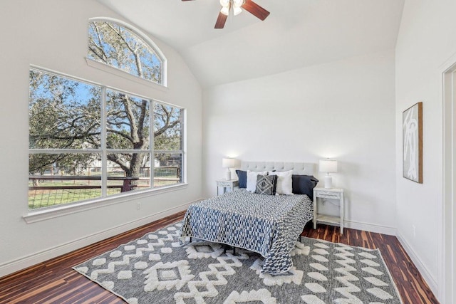 bedroom with a ceiling fan, baseboards, vaulted ceiling, and wood finished floors