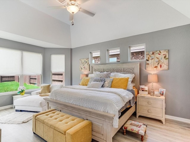 bedroom featuring a ceiling fan, vaulted ceiling, light wood-style flooring, and baseboards