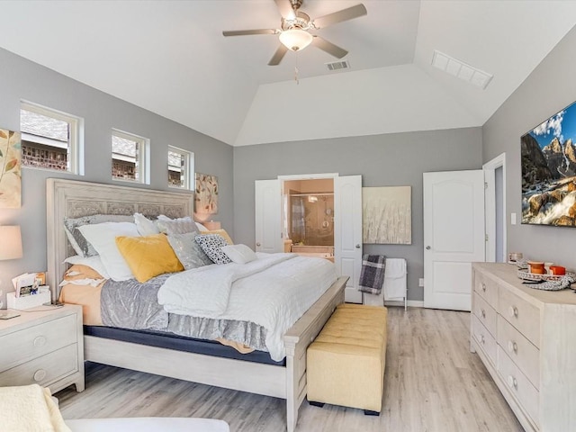 bedroom with lofted ceiling, light wood-style floors, and visible vents