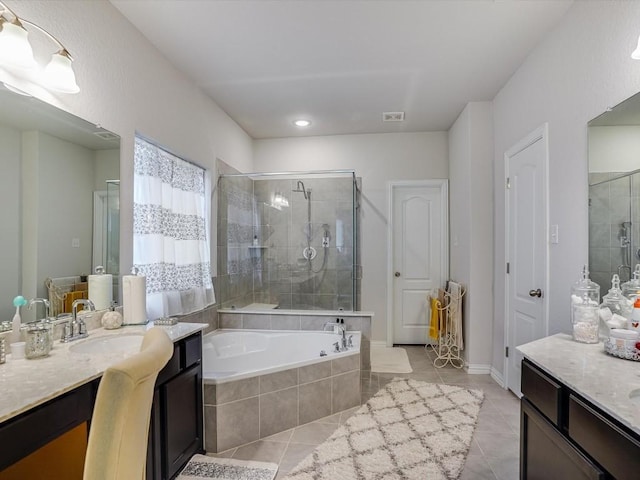 bathroom with a stall shower, visible vents, tile patterned floors, vanity, and a bath