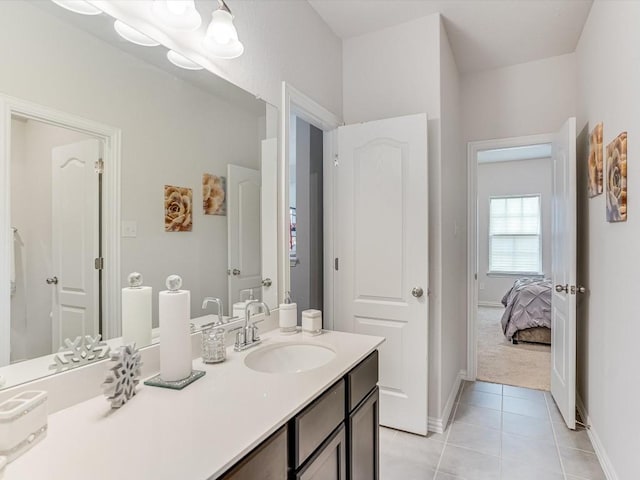 full bathroom with vanity, baseboards, ensuite bathroom, and tile patterned floors