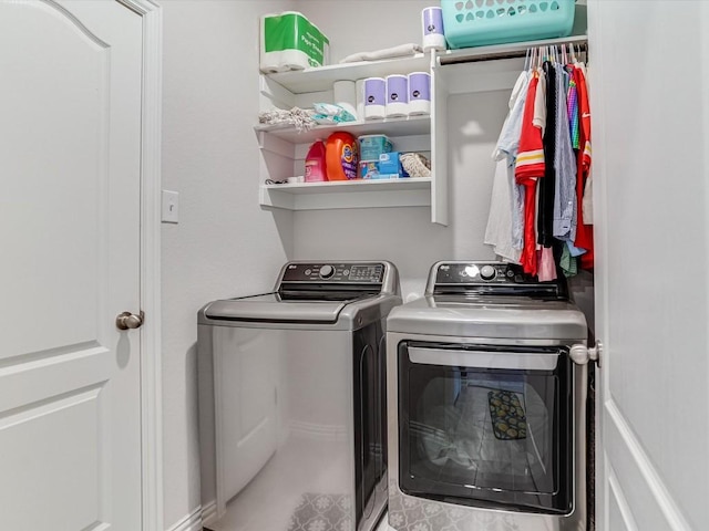 clothes washing area with washer and dryer and laundry area