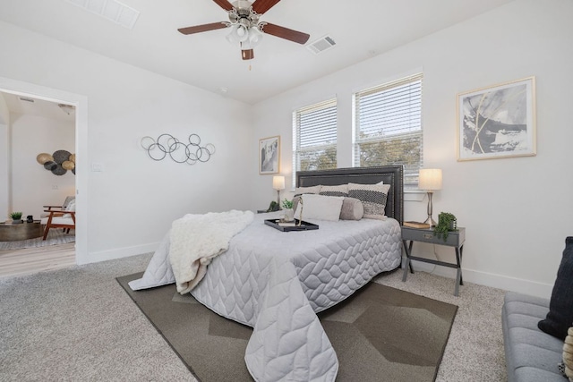 bedroom featuring ceiling fan, carpet flooring, visible vents, and baseboards