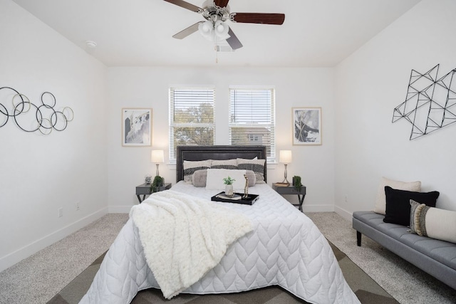 carpeted bedroom with ceiling fan and baseboards