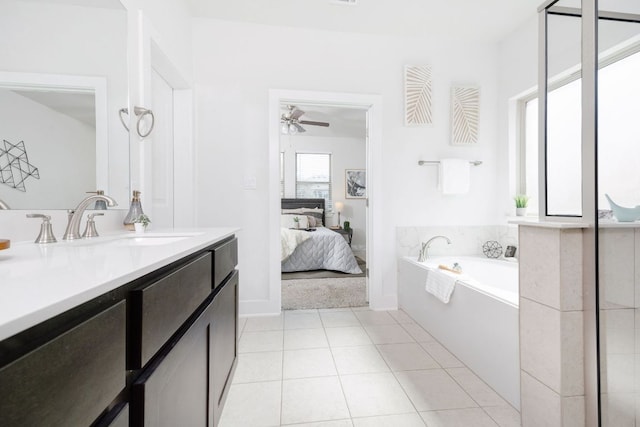 ensuite bathroom featuring ensuite bath, ceiling fan, tile patterned flooring, vanity, and a bath