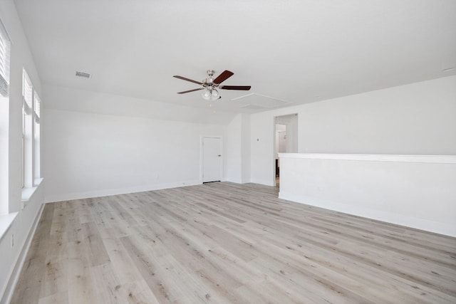 unfurnished room with light wood-style floors, baseboards, visible vents, and ceiling fan