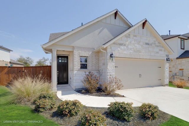 1409 Kneehigh Ln, Georgetown, TX 78633 - view of front of home featuring stone siding, board and batten siding, an attached garage, and concrete driveway