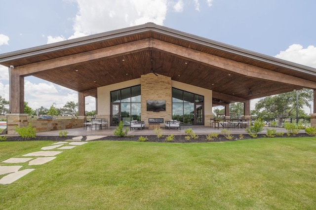 1409 Kneehigh Ln, Georgetown, TX 78633 - rear view of house featuring a fireplace, a patio, and a lawn