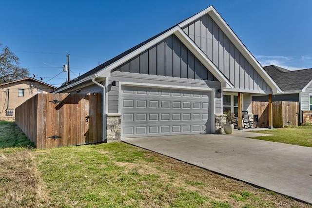 view of front of property featuring board and batten siding, concrete driveway, fence, and an attached garage