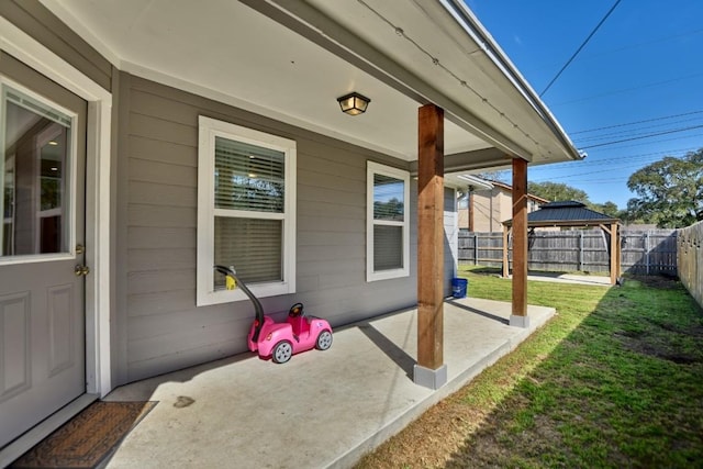 view of patio with a fenced backyard and a gazebo