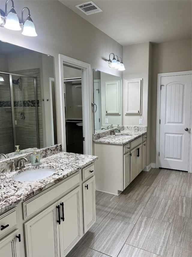 13825 Chester Knl, San Antonio, TX 78253 - full bath with a stall shower, two vanities, a sink, and visible vents