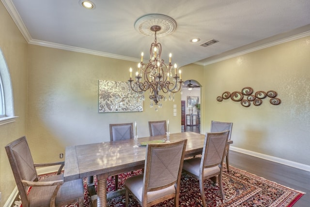 dining space featuring baseboards, visible vents, dark wood-style flooring, crown molding, and recessed lighting