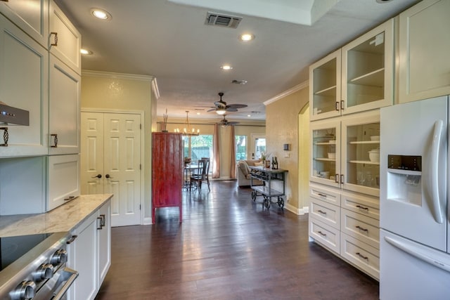 kitchen featuring white refrigerator with ice dispenser, stainless steel stove, visible vents, ornamental molding, and light stone countertops