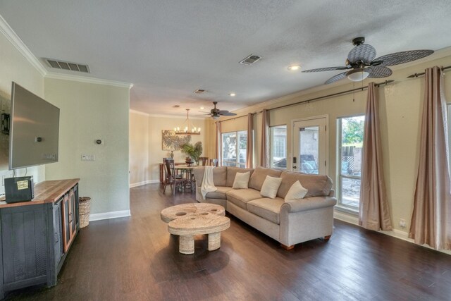 606 Free Rein, Horseshoe Bay, TX 78657 - living area featuring crown molding, a ceiling fan, dark wood-style flooring, baseboards, and a chandelier