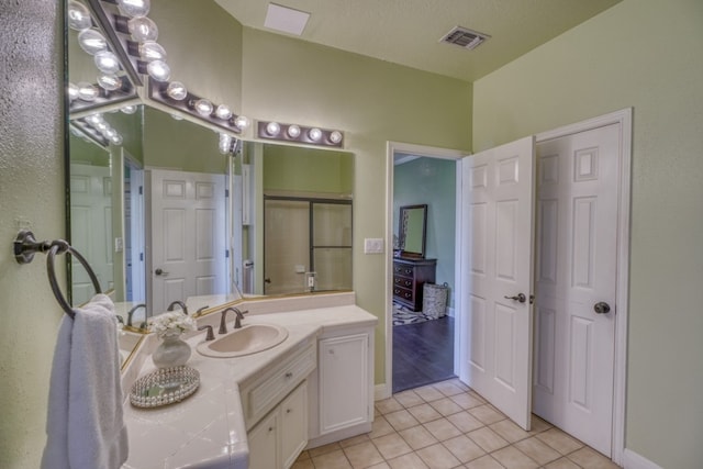 bathroom featuring tile patterned flooring, visible vents, and vanity