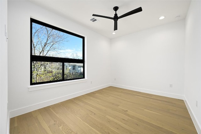 empty room with recessed lighting, light wood-type flooring, visible vents, and baseboards