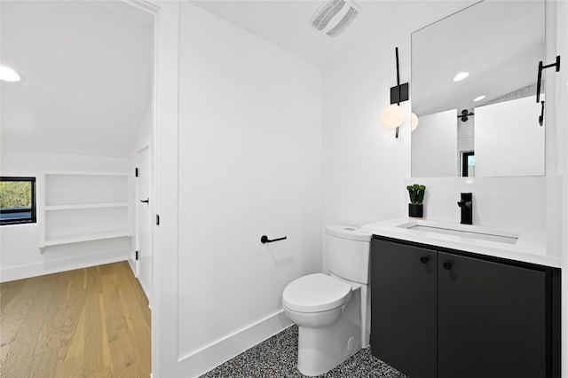 bathroom with visible vents, toilet, wood finished floors, vanity, and recessed lighting