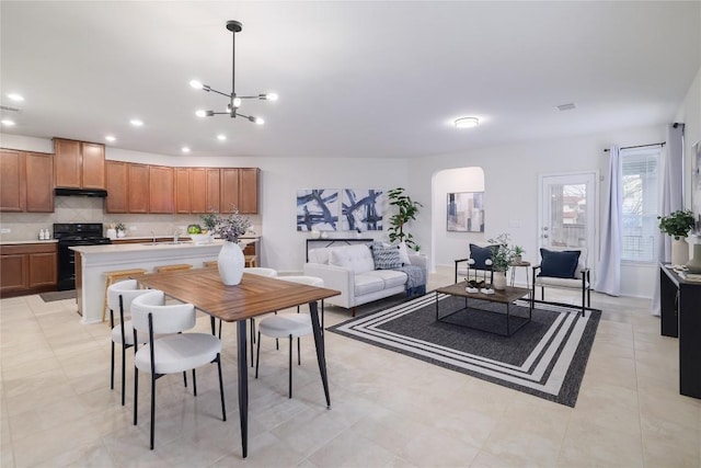 interior space with a chandelier, visible vents, and recessed lighting