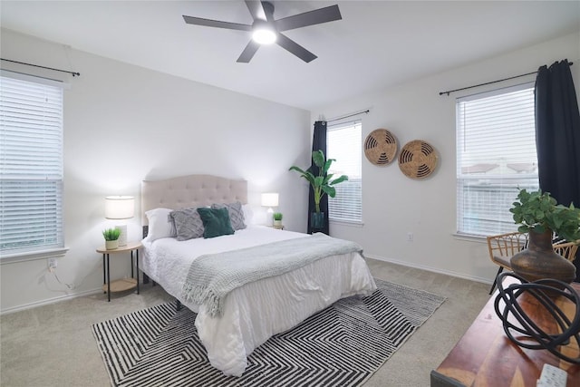 carpeted bedroom featuring a ceiling fan and baseboards