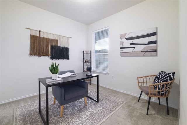 carpeted home office featuring baseboards