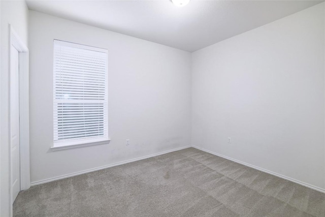 spare room with carpet floors and baseboards