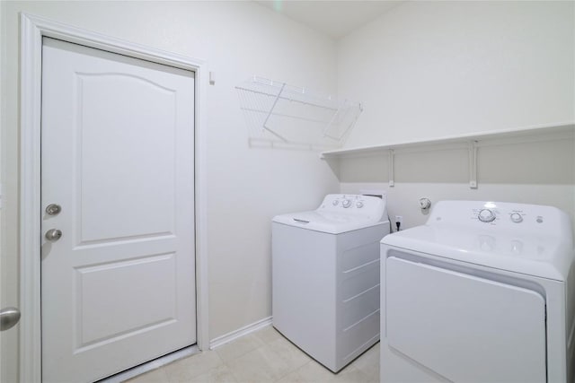 laundry area featuring laundry area, baseboards, and washing machine and clothes dryer