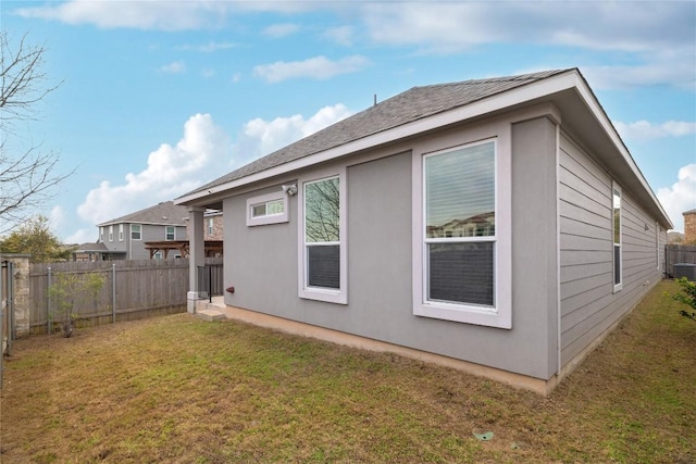 view of side of property with a fenced backyard and a yard