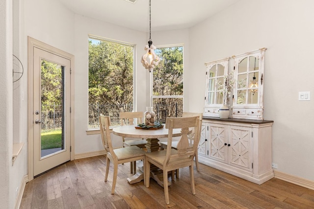 dining room featuring baseboards and hardwood / wood-style floors