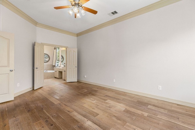 unfurnished bedroom featuring baseboards, ornamental molding, ensuite bath, and light wood-style floors