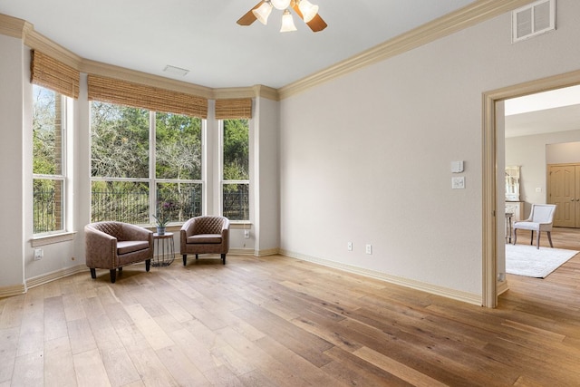 sitting room featuring baseboards, visible vents, and light wood-style floors