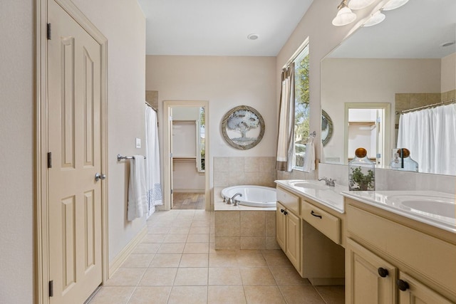 full bathroom featuring double vanity, a garden tub, tile patterned flooring, and a sink