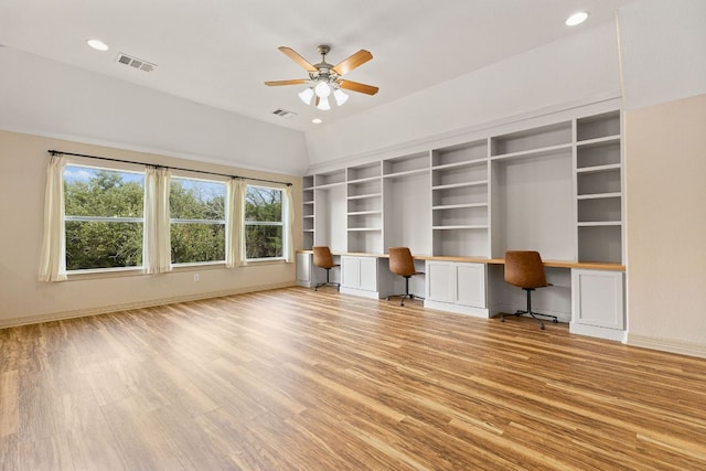 unfurnished office with light wood-type flooring, built in study area, visible vents, and baseboards