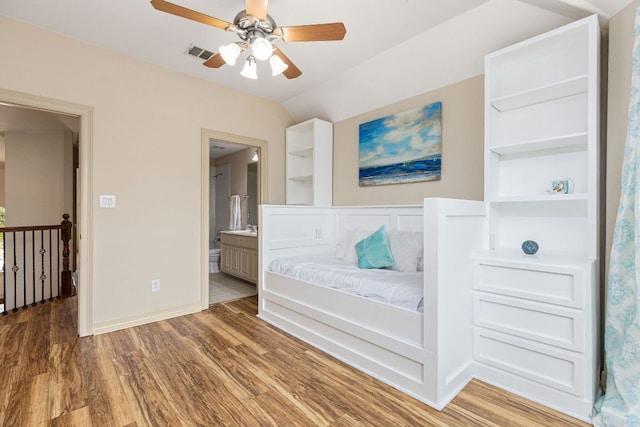 unfurnished room with lofted ceiling, ceiling fan, wood finished floors, visible vents, and baseboards