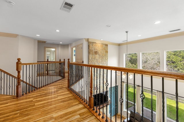 hallway featuring ornamental molding, wood finished floors, visible vents, and recessed lighting