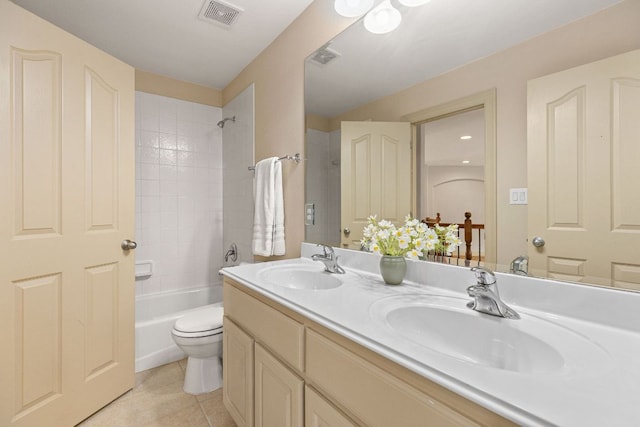 bathroom featuring double vanity, visible vents, a sink, and tile patterned floors