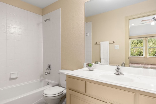 full bath with washtub / shower combination, a textured wall, vanity, and toilet