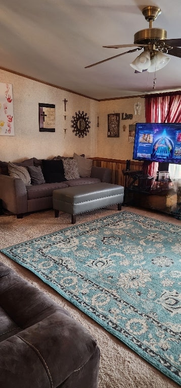 living room with crown molding and ceiling fan