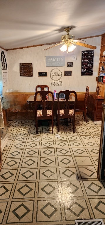 unfurnished dining area featuring ornamental molding, ceiling fan, and light floors