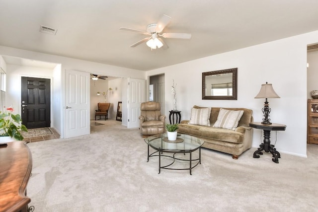 living room with ceiling fan, carpet flooring, visible vents, and baseboards