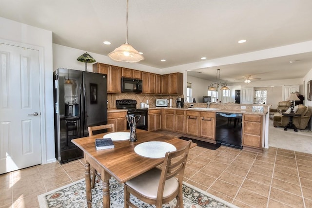 kitchen with tasteful backsplash, open floor plan, a peninsula, black appliances, and light tile patterned flooring