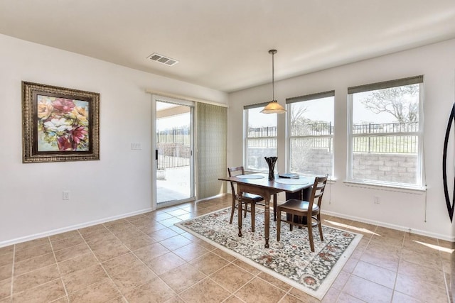 dining space with light tile patterned floors, baseboards, and visible vents