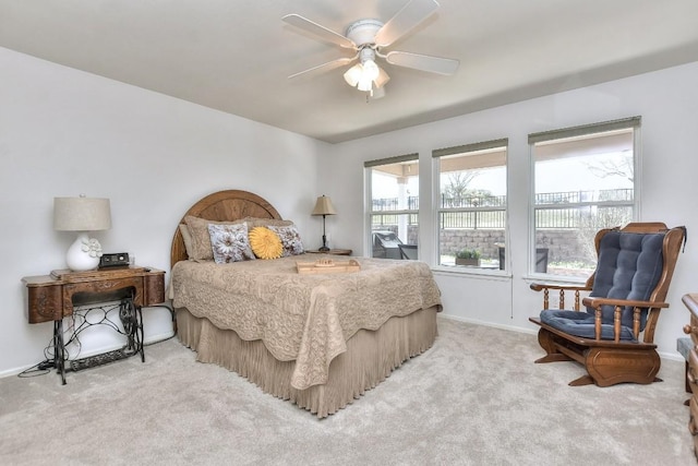 bedroom featuring light carpet, ceiling fan, and baseboards