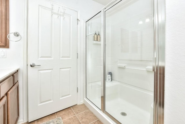 bathroom featuring a stall shower, vanity, and tile patterned floors