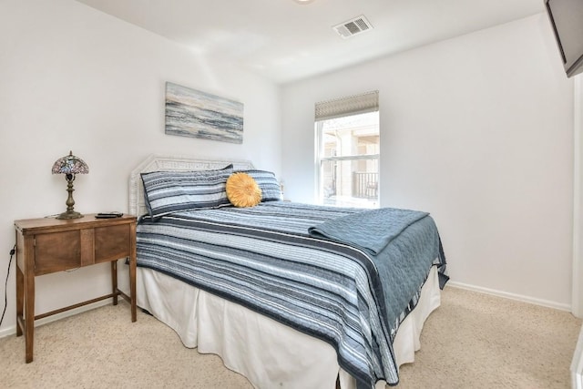 bedroom with carpet, visible vents, and baseboards