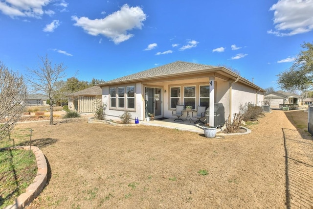 back of house with a patio and stucco siding