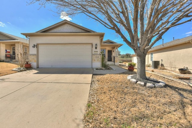 ranch-style home featuring concrete driveway, stone siding, an attached garage, and stucco siding