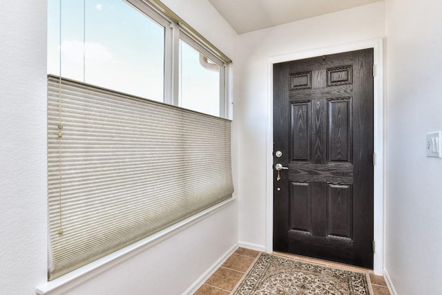 interior space featuring baseboards and tile patterned floors