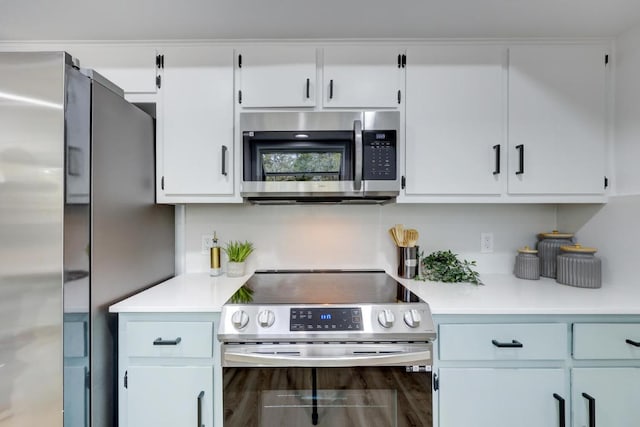 kitchen with white cabinetry, stainless steel appliances, and light countertops