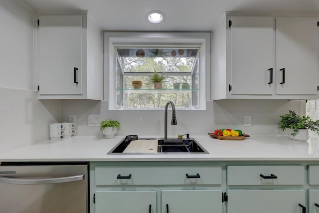 kitchen featuring a sink, light countertops, white cabinetry, stainless steel dishwasher, and recessed lighting