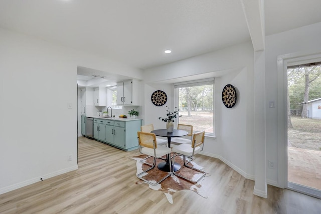 dining area with recessed lighting, baseboards, and light wood finished floors